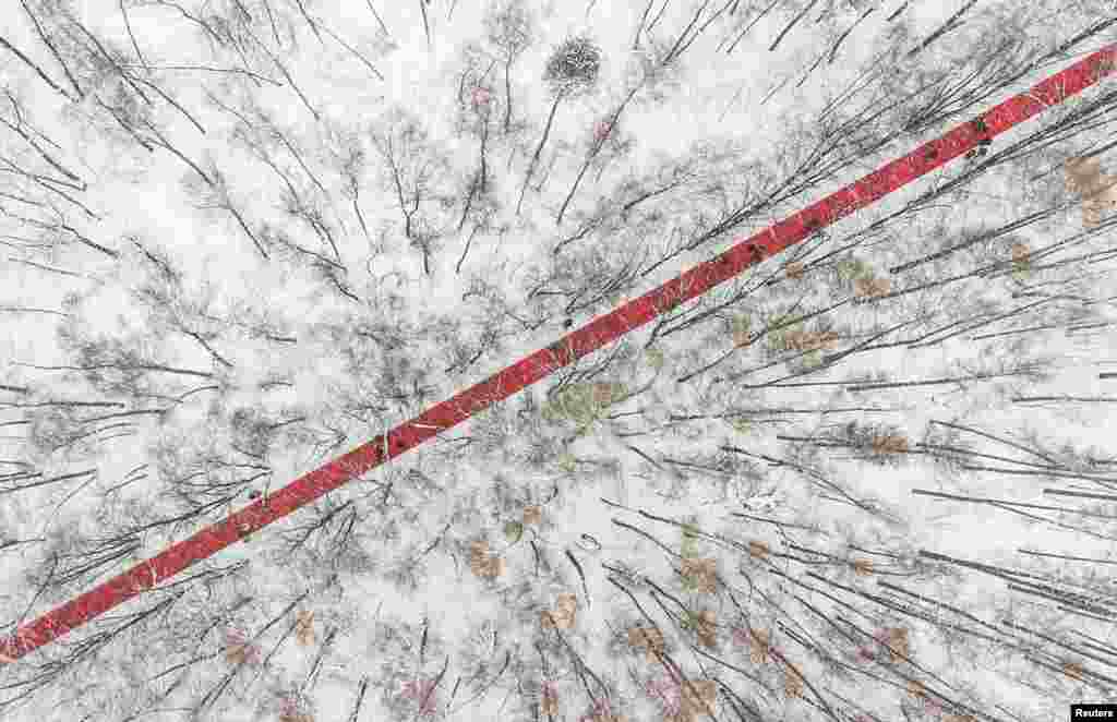 People walk at the art installation "Nowhere" by Gregory Orekhov at the Malevich park near the village of Razdory, outside Moscow, Russia.