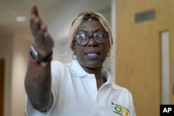 Michelle Dornelly from the Community Food Hub in the Hackney part of London said she used to have enough food to stay open until 4 p.m. each day. Now she has to close earlier. (AP Photo/Frank Augstein)
