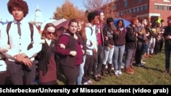  University of Missouri student protesters, led by a group called Concerned Student 1950 -- a reference to the year the university first admitted black students -- block access to Mel Carnahan quad on the campus in Columbia, Missouri, Nov. 9, 2015.