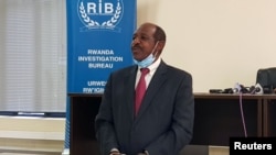 Paul Rusesabagina, the man who was hailed a hero in a Hollywood movie about Rwanda's 1994 genocide is paraded in handcuffs in front of media at the headquarters of Rwanda's Investigation Bureau, in Kigali, Aug. 31, 2020.