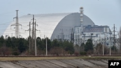 FILE - A giant protective dome built over the destroyed fourth reactor of the Chernobyl Nuclear Power Plant is seen April 13, 2021.