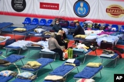 Displaced civilians from the Donetsk and Luhansk regions rest in a sport hall in Taganrog, Russia, Feb. 21, 2022.