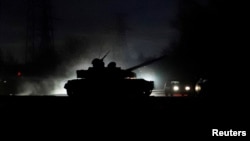 A tank drives along a street in the separatist-controlled city of Donetsk, Ukraine Feb. 22, 2022, after Russian President Vladimir Putin ordered the deployment of Russian troops to two breakaway regions in eastern Ukraine following the recognition of thei