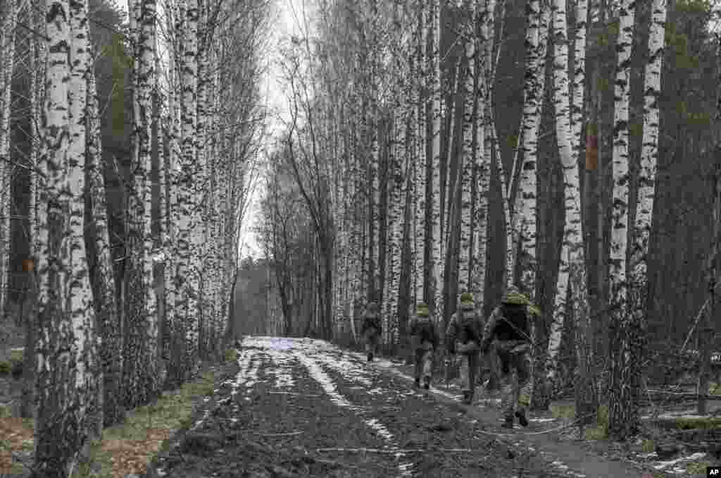 Ukrainian border guard officers patrol the Ukrainian-Belarusian state border at a checkpoint in Novi Yarylovychi.