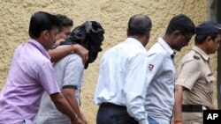olice officials escort an accused, head covered with black cloth, in the gang rape of a young photojournalist in the Indian financial hub of Mumbai, Aug. 24, 2013.