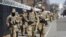 National Guard soldiers walk near the Capitol, March 4, 2021, on Capitol Hill in Washington.