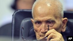 FILE - In this photo released by the Extraordinary Chambers in the Courts of Cambodia, Nuon Chea, who was the Khmer Rouge's chief ideologist and No. 2 leader, sits in a courtroom before a hearing at the U.N.-backed war crimes tribunal in Phnom Penh.
