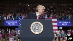 President Donald Trump pauses while speaking at a rally at the Kentucky Exposition Center in Louisville, Ky., March 20, 2017.