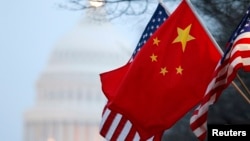 The People's Republic of China flag and the U.S. Stars and Stripes fly along Pennsylvania Avenue near the U.S. Capitol in Washington during Chinese President Hu Jintao's state visit