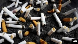 In this April 7, 2017 photo, cigarette butts are discarded in an ashtray outside a New York City office building. (AP Photo/Mark Lennihan)