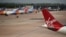 Virgin Atlantic, TUI, and Jet2 aircraft stand near departure gates at Manchester Airport in Manchester, northern England on May 11, 2020, 