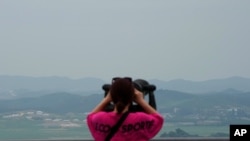 A visitor views the North Korea side from the Unification Observation Post in Paju South Korea, near the border with North Korea, Thursday, June 17, 2021. The North Korea's official Korean Central News Agency said Wednesday, June 16, 2021, that…