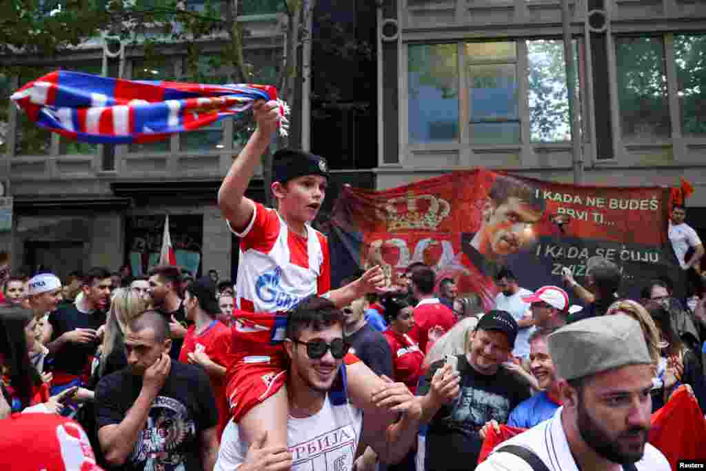 Supporters of Serbian tennis player Novak Djokovic rally in the street outside what is believed to be the location of his lawyer's office during an ongoing day of legal proceedings over the cancellation of his visa to play in the Australian Open in Melbourne.