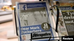 The front page of Norway's Aftenposten is seen at a news stand in Oslo, Norway, Sept. 9, 2016. The newspapers chief editor accused Facebook of abusing its power after it deleted an 1972 iconic image of a nude Vietnamese girl running from a napalm attack.