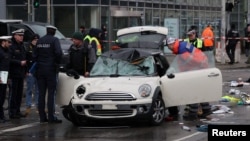 Police work at a car which drove into a crowd in Munich, Germany, Feb. 13, 2025, injuring several people.