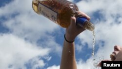 Seen from above, clothing dries on the stairs of a sports field being used by residents displaced one week after the 7.2 magnitude earthquake in Les Cayes, Haiti.