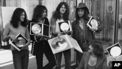 FILE - British rock band Deep Purple present their golden record they received in West Berlin for the sales of their latest album, "Deep Purple in Rock," in West Germany, Sept. 1, 1971.