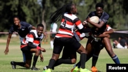 Members of the Zimbiru Rugby Academy Club, an all-female rugby team, play a match in the capital Harare, in Zimbabwe, April 29, 2023. (REUTERS/Philimon Bulawayo)