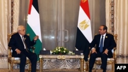 This handout picture released by the Palestinian Authority's press office shows Palestinian Authority President Mahmoud Abbas, left, meeting with Egypt's President Abdel-Fattah el-Sissi during the Arab League Summit on Gaza, in Cairo, on March 4, 2025.