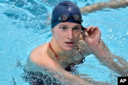 FILE - Transgender swimmer Lia Thomas speaks to her coach after winning the 500 meter freestyle during a meet with Harvard on Jan. 22, 2022, at Harvard University in Cambridge, Mass. (AP Photo/Josh Reynolds, File)