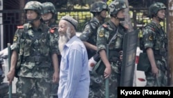 Polisi China berjaga di dekat bazar internasional di Urumqi, Wilayah Otonomi Xinjiang Uighur, 29 Juni 2013. (Foto: Kyodo via Reuters)