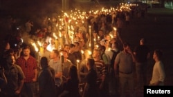 White nationalists carry torches on the grounds of the University of Virginia, on the eve of a planned "Unite the Right" rally in Charlottesville, Va., Aug. 11, 2017.