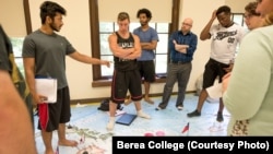 Standing on a map of Asia, Berea College students in a foreign policy class work policy on a crisis exercise. Berea, in Kentucky, offers free tuition to all its students.