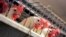 FILE - Chickens huddle in their cages at an egg processing plant at the Dwight Bell Farm in Atwater, California, Sept. 10, 2008. 