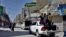 A convoy of police patrols in a market to enforce lockdown to help control the spread of the coronavirus, in Quetta, Pakistan, Sunday, May 9, 2021. (AP Photo/Arshad Butt)