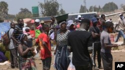 People are seen at a busy market in a poor township on the outskirts of the capital Harare, Nov, 15, 2021.