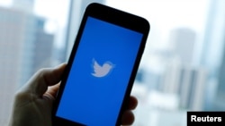 FILE - The Twitter App loads on an iPhone in this illustration photograph taken in Los Angeles, California, July 22, 2019. 