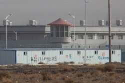FILE PHOTO - In this Dec. 3, 2018, a guard tower and barbed wire fences are seen around a facility in the Kunshan Industrial Park in Artux in western China's Xinjiang region.