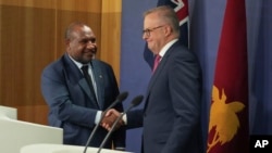 Australian Prime Minister Anthony Albanese, right, shakes hands with Papua New Guinea Prime Minister James Marape at a press conference in Sydney, Australia, Dec. 12, 2024. 