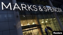 FILE - A man leaves a Marks & Spencer store in London, Britain. Orient Craft, an Indian company exporting to retailers such as Marks and Spencer in Britain, says it is deeply worried about the upcoming June 23 referendum.