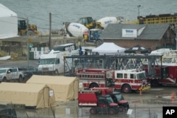 Emergency vehicles and recovery operations are seen near the mouth of the Anacostia River at the Potomac River near Ronald Reagan Washington National Airport, Jan. 31, 2025.