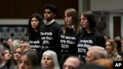 Protesters stand up during a Senate Judiciary Committee hearing with social medial platform heads on Capitol Hill in Washington, Jan. 31, 2024, to discuss child safety.