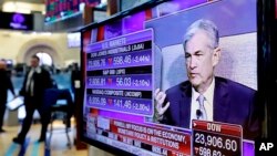 Federal Reserve Chairman Jerome Powell's appears on a screen on the floor of the New York Stock Exchange, April 6, 2018.