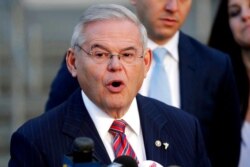 FILE – U.S. Sen. Bob Menendez, D-N.J., speaks to reporters in Newark, Nov. 16, 2017.
