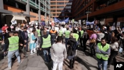 FILE - Hundreds of protesters rally outside the Immigration Department offices in Sydney, Australia, Aug. 12, 2019. The protest was to highlight the uncertain futures of many refugees since Australia had replaced permanent protection visas with temporary visas. 