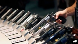 In this Jan. 19, 2016 photo, handguns are displayed at the Smith & Wesson booth at the Shooting, Hunting and Outdoor Trade Show in Las Vegas. (AP File Photo/John Locher)