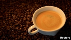An illustration picture shows a coffee cup and roasted coffee beans in Brussels, Belgium May 1, 2017. (REUTERS/Eric Vidal/Illustration)