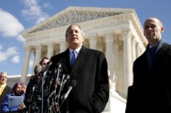 FILE - Texas Attorney General Ken Paxton addresses reporters on the steps of the U.S. Supreme Court in Washington.