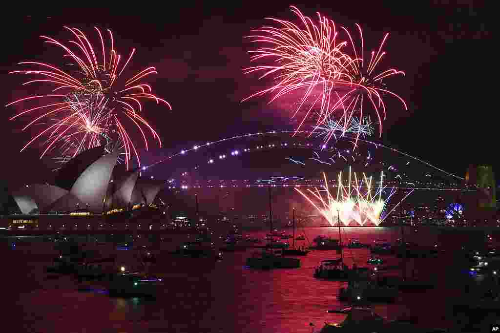 Fireworks explode over the Sydney Opera House and Harbour Bridge as New Year's Eve celebrations begin in Sydney.