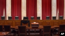 This photo provided by the Collection of the Supreme Court of the United States shows the Courtroom of the Supreme Court showing Associate Justice Antonin Scalia’s Bench Chair draped in black, Tuesday, Feb. 16, 2016, at the court in Washington. (Franz Jantzen/Collection of the Supreme Court of the United States via AP)