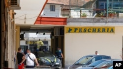 Police officers patrol an apartment complex area where dozens of COVID-19 cases have been registered among a community of Bulgarian farm workers, in Mondragone, in the southern Italian region of Campania, June 26, 2020.