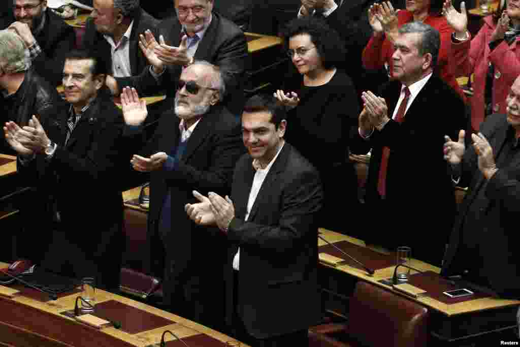 Alexis Tsipras, opposition leader and head of radical leftist Syriza party, and his party's lawmakers applaud after the last round of a presidential vote in Athens, Dec. 29, 2014.&nbsp;