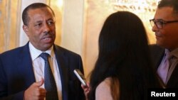 FILE - Libya's Prime Minister Abdullah al-Thinni speaks to reporters in Abu Dhabi.