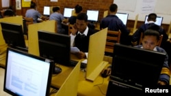 FILE - Students use computers to study at Elswood Secondary School in Cape Town, Nov. 7, 2013. U.S. law enforcement agencies and tech giants are getting ready to face off on the issue of digital privacy.