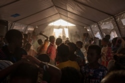 Tigray refugee children sing and dance inside a tent run by UNICEF for children's activities, in Umm Rakouba refugee camp in Qadarif, eastern Sudan, Dec. 10, 2020.