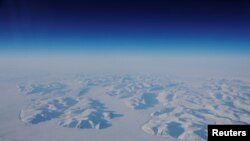 Glacial ice is seen from the window during a NASA flight to support the Oceans Melting Greenland (OMG) research mission above the east coast of Greenland, March 13, 2018. REUTERS/Lucas Jackson 